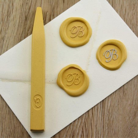 Bright yellow wax seal impression on envelope