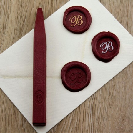 Shimmering metallic red wax seal impression on envelope