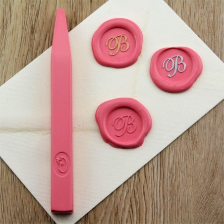 Pink wax seal impression on envelope